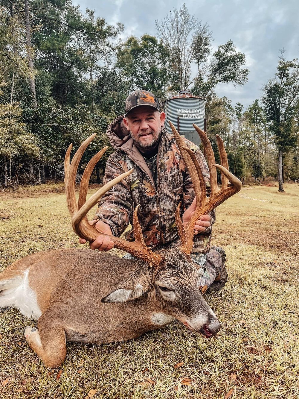 Hunter aiming at whitetail deer in Florida forest